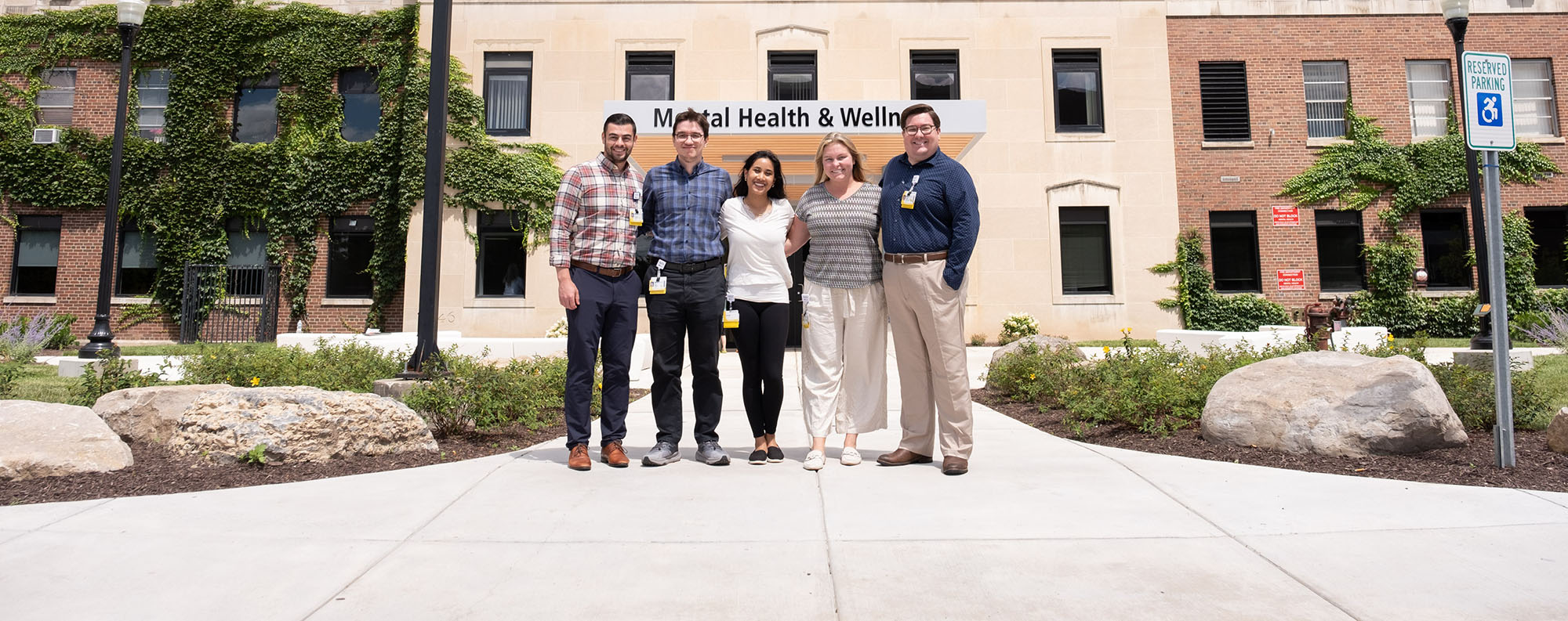 four residents standing in front of mental health building