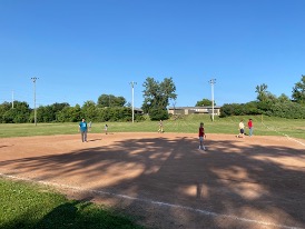 Students participate in softball game