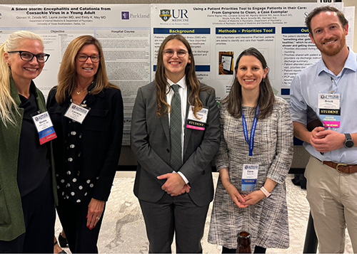 group standing infront of poster at conference