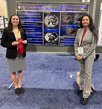 Alexandra France and Shivangi Kothari present their poster at the American College of Gastroenterology conference 2024