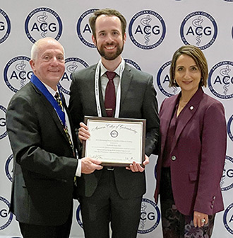 Robin Willson, center, receives Outstanding Research Award by a Fellow in Training