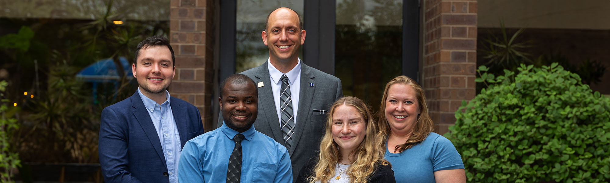 Pharmacy residents in front of a building