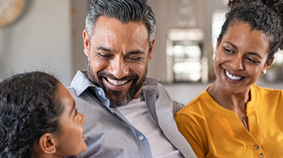 family smiling at each other