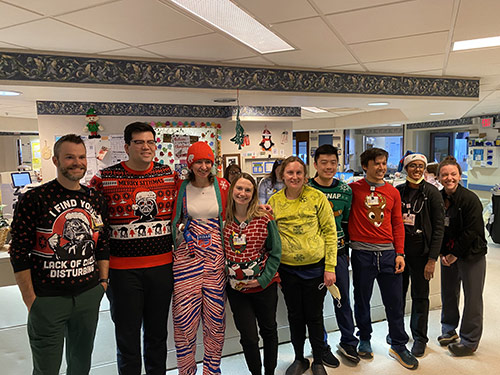 Pulmonary team model ugly holiday sweaters