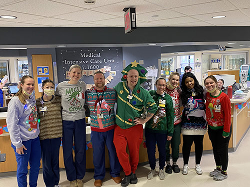 Pulmonary team model ugly holiday sweaters